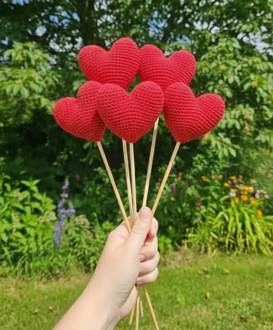 Close-up of handmade Valentine’s Day crochet heart bouquet on wooden skewers